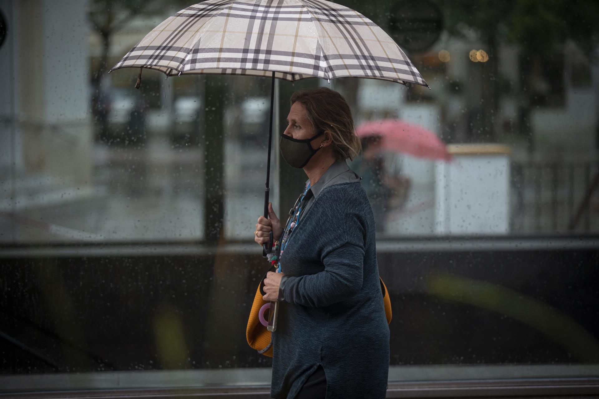 Una mujer se protege bajo su paraguas durante una jornada de lluvia. / Foto: María José López. / Europa Press.